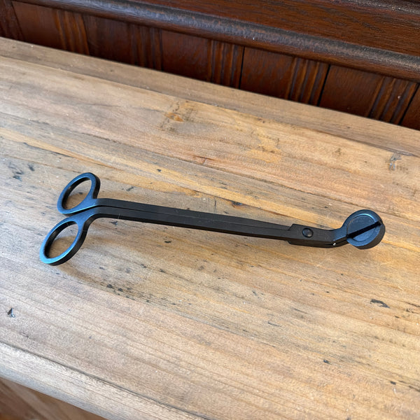 Flame On Main Wick Trimmer in matte black metal, designed for precise candle wick maintenance, displayed on rustic wooden surface, ideal for decor and gifting from Knotty and Board.