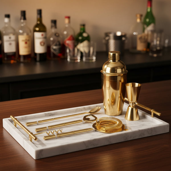 Gold Stick Bar Set 4 PC. displayed in a box on a marble surface, featuring a cocktail shaker, bottle opener, corkscrew, jigger, and strainer in polished gold finish, perfect for stylish entertaining.