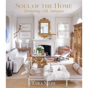 Elegant living room featuring classic antique decor with white furniture, a gold-framed mirror, ornate wooden cabinet, and soft accents, illustrating "Soul of the Home" style.