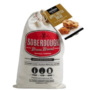 A natural cotton bag of Soberdough Brew Bread, Apple Fritter artisan beer bread mix with a label showing bread pieces, perfect for kitchen or gift decor from Knotty and Board.