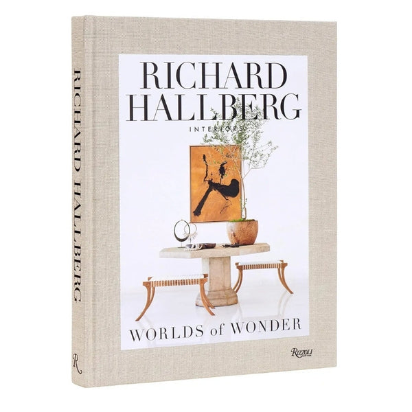 Hardcover book titled Hallberg Worlds of Wonder with a beige fabric cover featuring minimalist interior decor art on the front, ideal for Knotty and Board decor and gift collections.