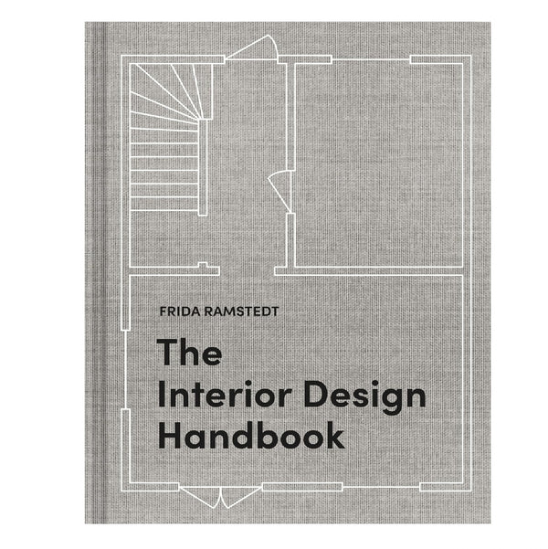 The Interior Design Handbook book cover featuring a minimalist architectural floor plan line drawing on a textured gray background, available at Knotty and Board with curated decor and gifts.