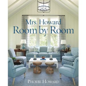 Cozy living room with soft blue armchairs, wooden stools, and a large window, highlighting styled home decor in Mrs. Howard, Room by Room.