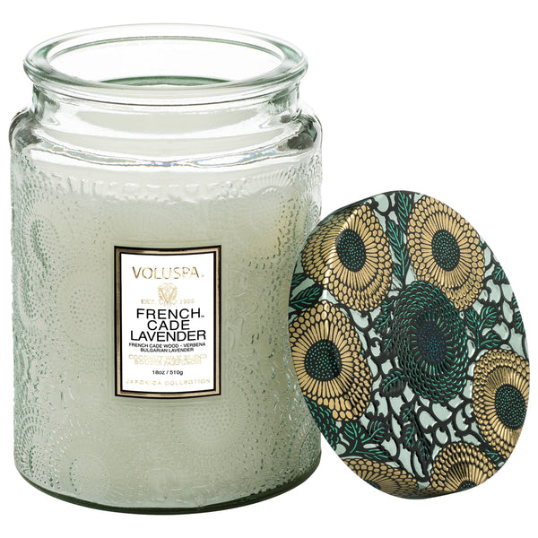 Voluspa French Cade Large Jar Candle, 18 oz with a textured glass jar and a decorative floral lid, featured by Knotty and Board as a stylish decor piece and gift option.