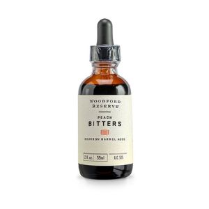 Bourbon Barrel Foods Woodford Reserve Peach Bitters, 2 oz., dropper bottle with a simple cream label, perfect for kitchen and entertaining gifts from Knotty and Board.