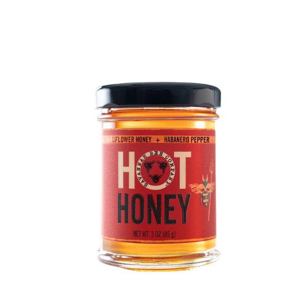 Savannah Bee Co., Hot Honey, 3 oz. jar with a red label featuring a bee design, perfect for kitchen gifts and entertaining from Knotty and Board.