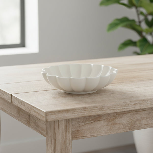 White porcelain decorative bowl shaped like a blossom with soft petal-like edges, perfect for kitchen or dining decor from Knotty and Board, titled Porcelain Blossom Bowl, 12 X 3.