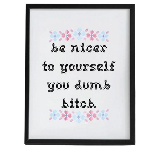 Framed Be Nicer To Yourself Dumb Bitch Art Print, 8 X 10 in. featuring black cross-stitch style text with pastel pink and blue floral accents, perfect for Knotty and Board decor gifts.