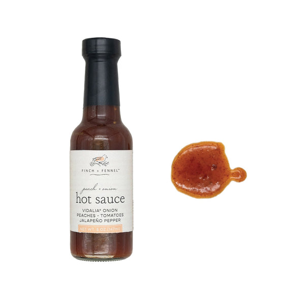 Peach + Onion Hot Sauce, 5 oz bottle with a sample of the hot sauce showcasing its rich, reddish-brown color, perfect for kitchen and dining use from Knotty and Board.
