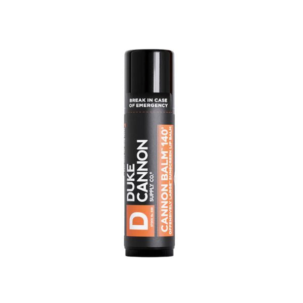 Duke Cannon Balm 140° Tactical Lip Balm, Blood Orange Mint in a black tube with bold white and orange text, perfect unique gift from Knotty and Board for everyday lip care.