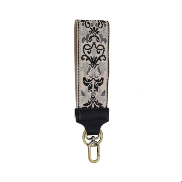 Easy Find Wristlet, Grey Floral Filigree Embroidered with an elegant grey and black embroidered design and a gold-tone clasp, perfect for stylish organization from Knotty and Board. Every Room Needs A Little Knotty and Board.