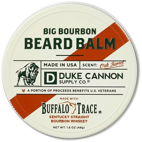 Round tin container of Duke Cannon Beard Balm, 1.6 oz., Big Bourbon with vintage-inspired design highlighting oak barrel scent and Buffalo Trace bourbon whiskey, offered by Knotty and Board.