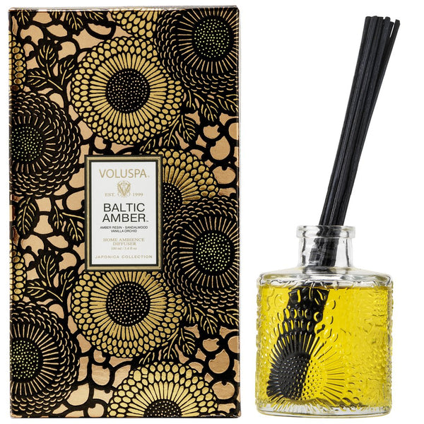 Voluspa Baltic Amber Reed Diffuser, 3.4 fl oz with textured glass bottle and black floral decorative packaging, an elegant home decor gift from Knotty and Board.